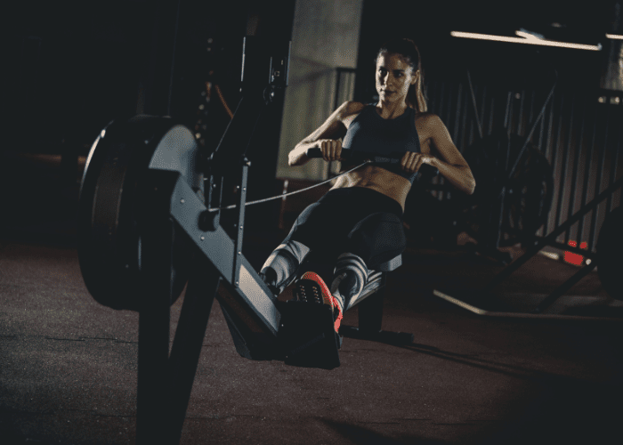 woman burning calories on rowing machine