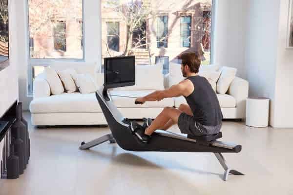 Man using Hydrow rower in living room