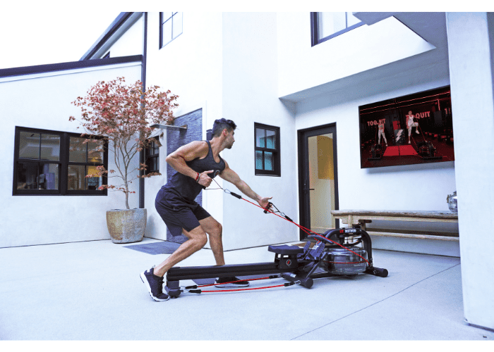 Guy doing resistance band workout on the LIT Strength Machine