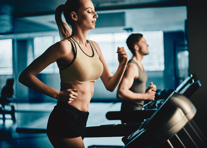 Woman and man running on treadmill