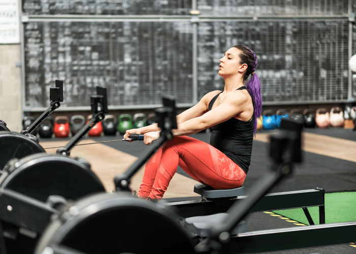 Is rowing good for your back, woman using rowing machine