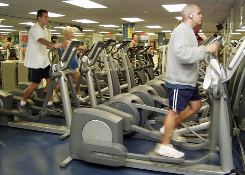 People using cross trainers at a gym